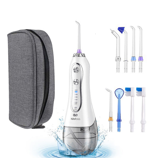 White dental water flosser with gray carrying case and various nozzles on a white background
